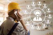 Worker with yellow hard hat talking on the phone, next to it a diagram of several conference participants