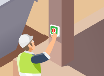 A construction worker presses a button attached to a pillar.