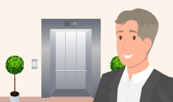 Man in a suit smiling in front of an elevator